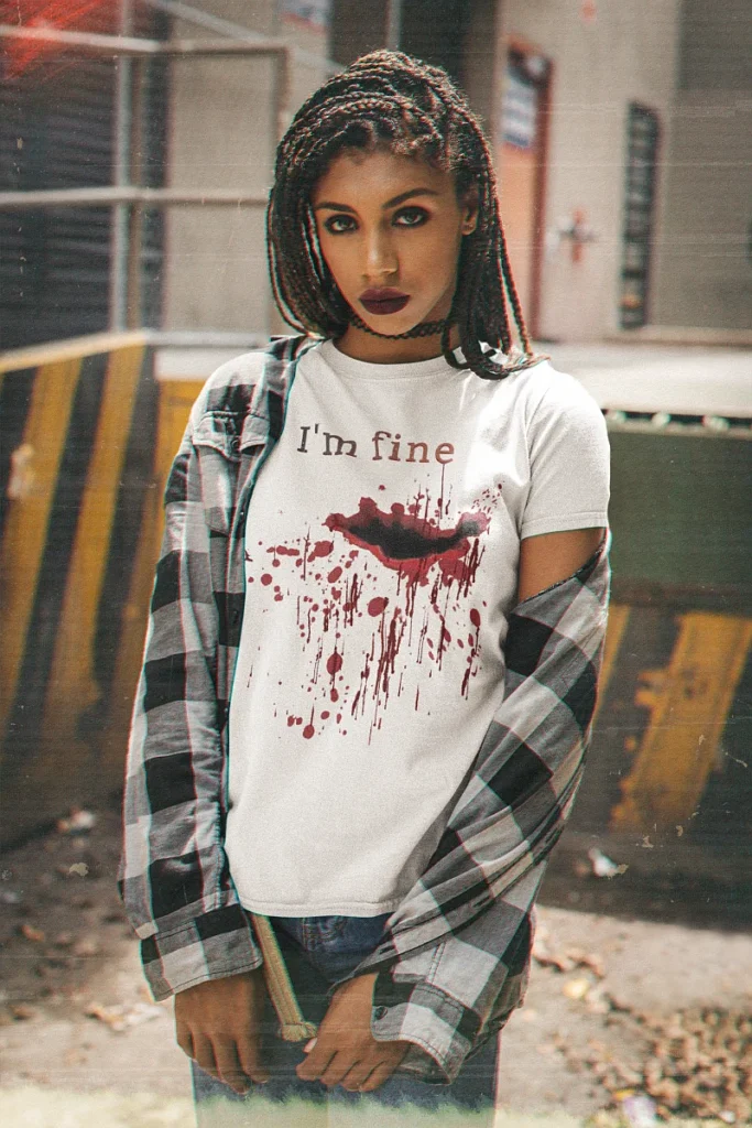 Woman wearing a white I am fine bloody t shirt with flesh wound horror design