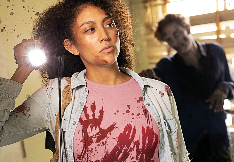 Woman wearing a bloody t shirt in a zombie apocalypse scene